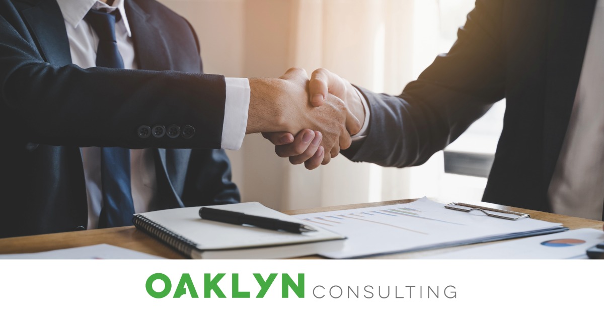 Two Men shaking hands over a contract