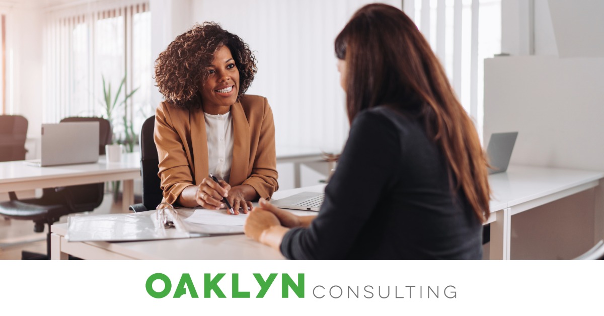 a woman explaining bank info to another